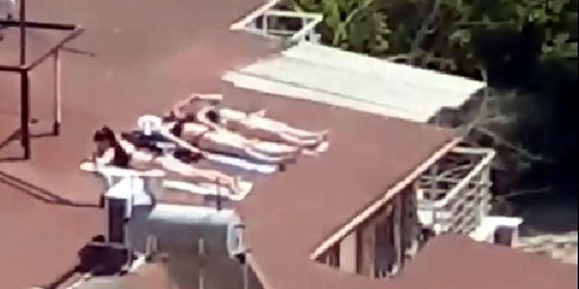 Corona virüs nedeniyle çatıda bikinili, mayolu güneşlenme
